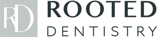 The image features the logo for a dental practice called Rooted Dentistry. The design includes two main elements: on the left, a stylized "RD" in white against a light gray background, and on the right, the bold, black text "ROOTED DENTISTRY."