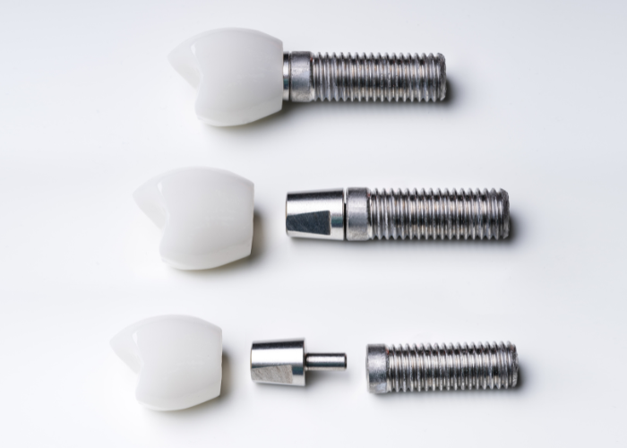 Different types of dental implants in a plain white background.
